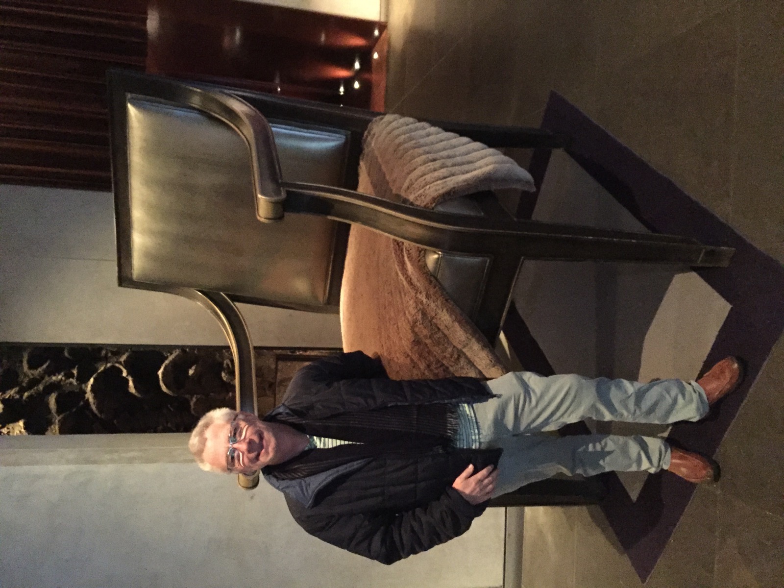 Older traveller beside a large chair