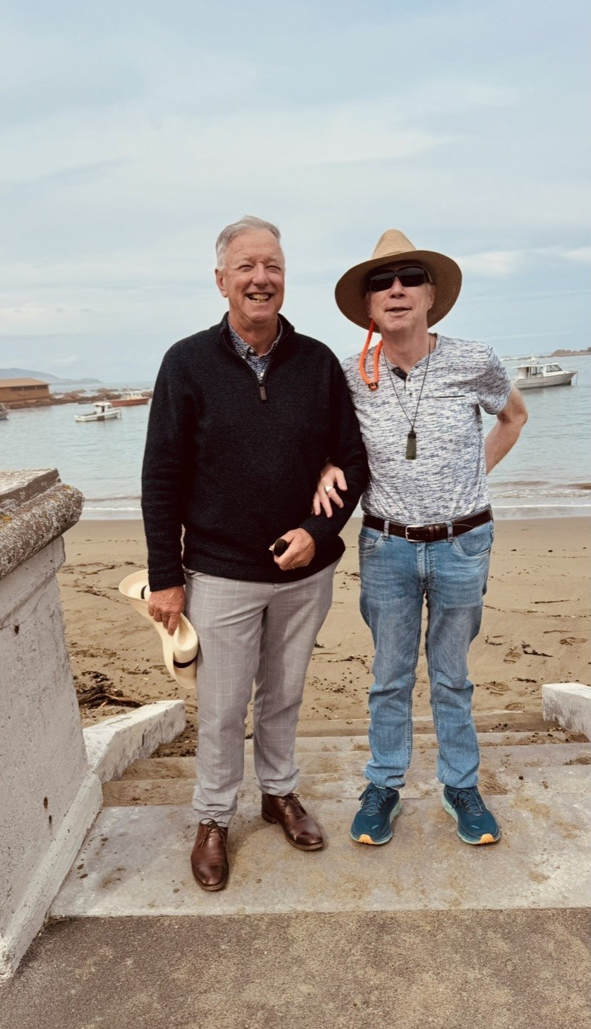 Older travellers walking at the beach
